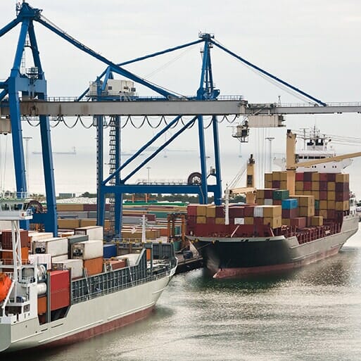Container ship alongside port cranes